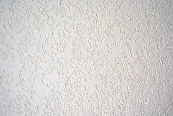 Close-up view of knock-down ceiling texture, featuring a smoothed orange peel pattern. Highly decorative, suitable for modern aesthetics.