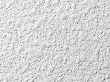Close-up view of Spantex, also known as orange peel ceiling texture, featuring a subtle, textured pattern. Popular choice for modern and traditional styles.