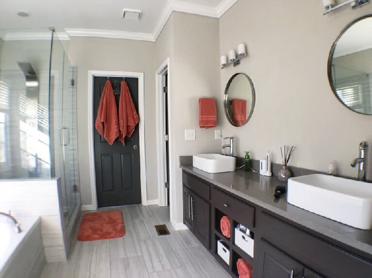 Modern bathroom renovation - clean lines, frameless shower, sleek tiles, trendy paint. Trust The Renovator for your dream bathroom