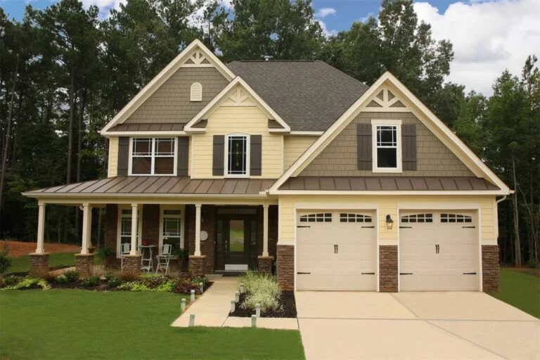 Mega house with freshly painted siding, porch, fascia, and casing in earth tones that beautifully complement the roof colors.