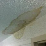 Water Damage affecting drywall in the ceiling. This is a result of a leak. brown stains observed near the corner.