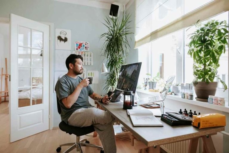 Homeowner working from a cozy basement office, with ambient lighting.
